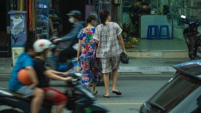 Two women jaywalking across a street, highlighting whether or not jaywalking is still a crime