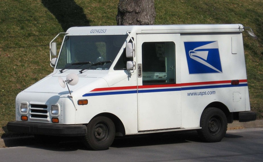 A Grumman LLV mail truck sits in a local neighborhood.