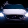 White Volvo car with shining headlights, highlighting reasons why car have two headlights instead of one