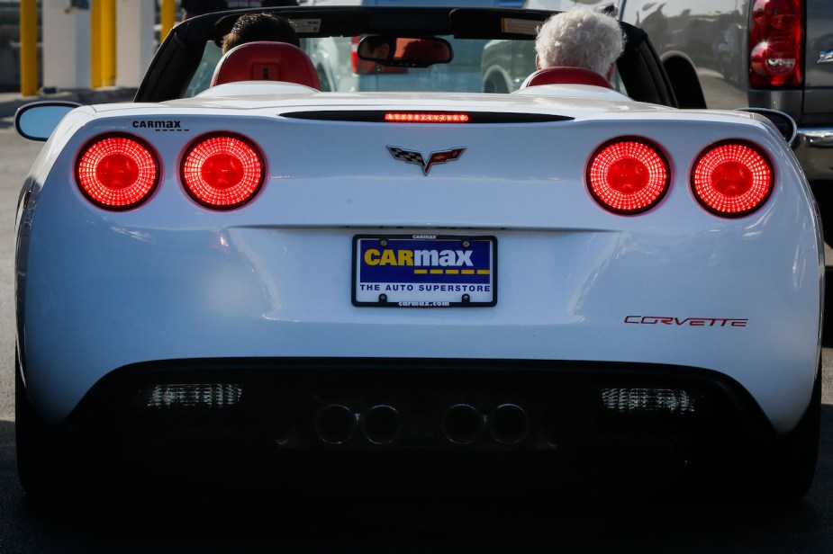 A customer goes on a test drive in a used Chevrolet Corvette.