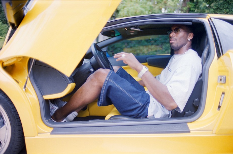 Kobe Bryant poses with his Lamborghini