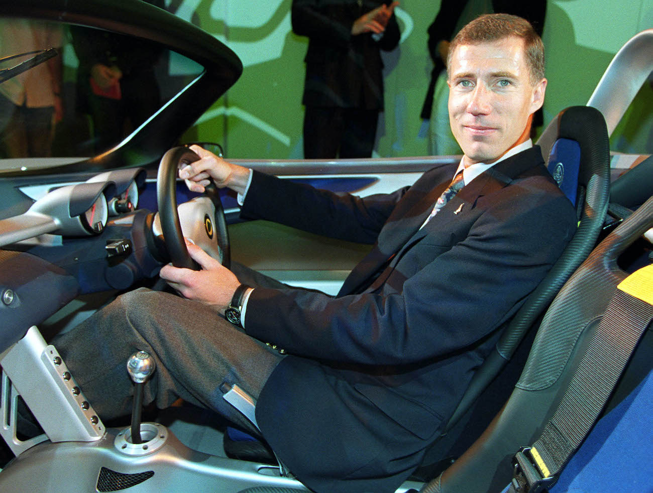 A tall driver sits in a Lotus Elise.