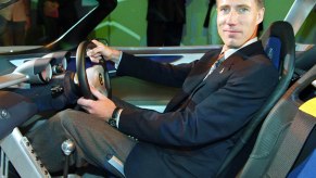 A tall driver sits in a Lotus Elise.
