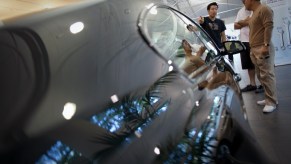 A man sells a BMW to a couple.