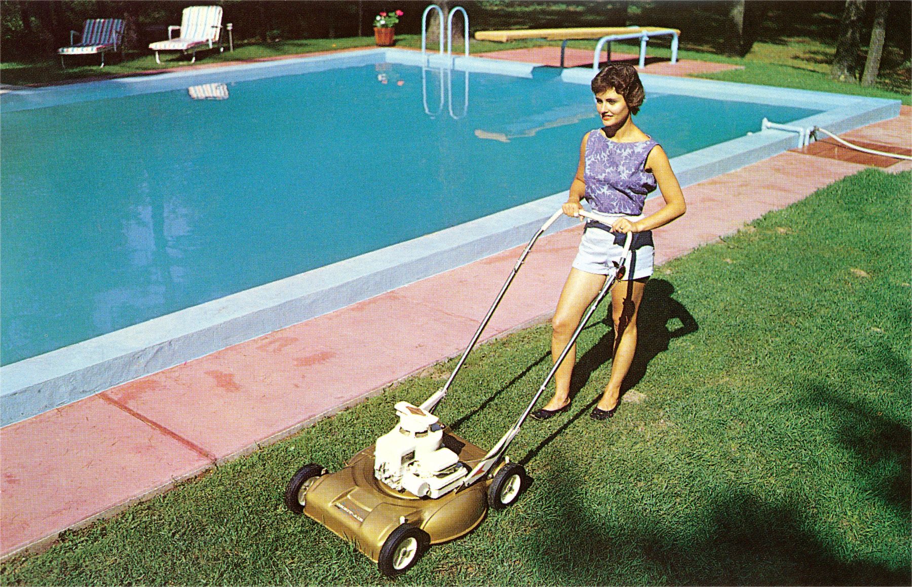 A woman mowing her lawn and cutting grass by the pool