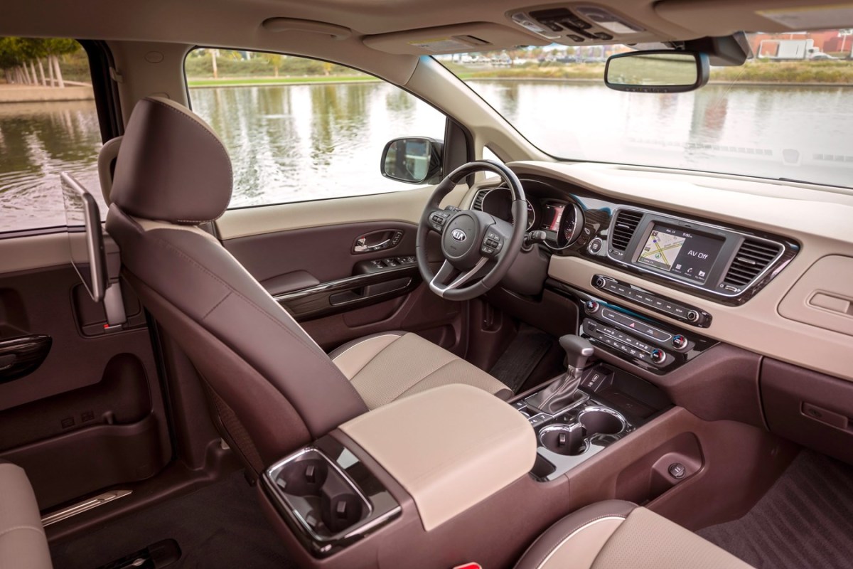 The interior of a Kia Sedona in brown and tan. 