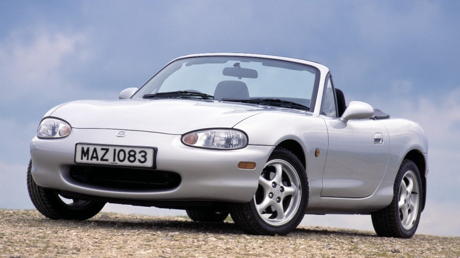 a silver 1999 mazda mx 5 miata, a fun to drive roadster that is among the fastest models offered