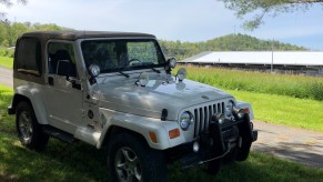 A white 2000 Jeep Wrangler in a field