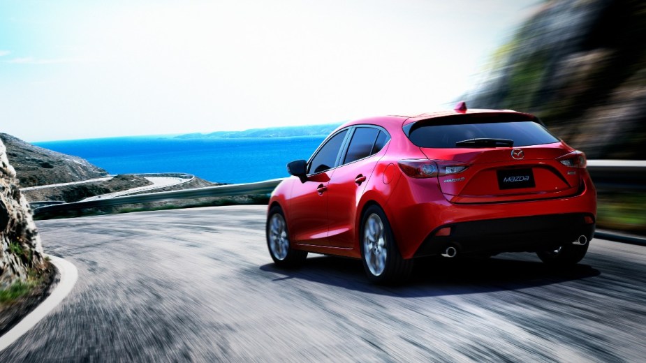 a red 2014 mazda3 hatchback, an upscale and sporty hatchabck