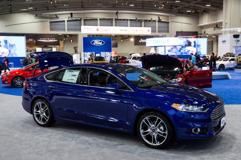 A blue 2015 Ford Fusion parked inside. It's one of the best used Fusion model years to buy. 