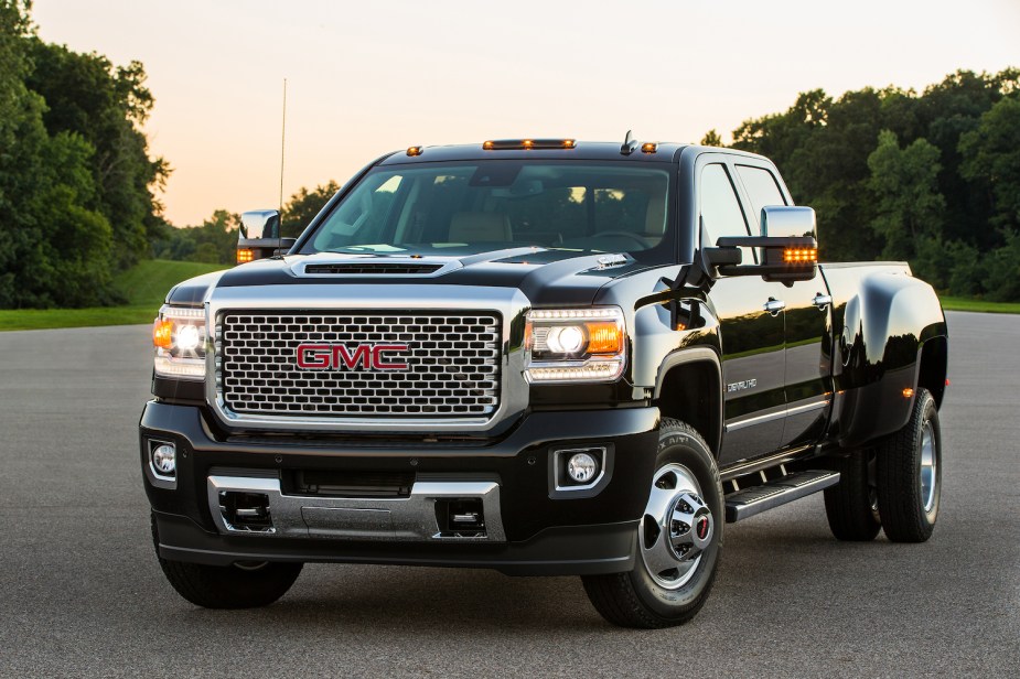 This is a black, heavy-duty GMC pickup truck with optional yellow clearance marker lights installed.