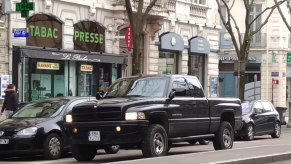 A 2018 Ram 1500 in black drives on the road.