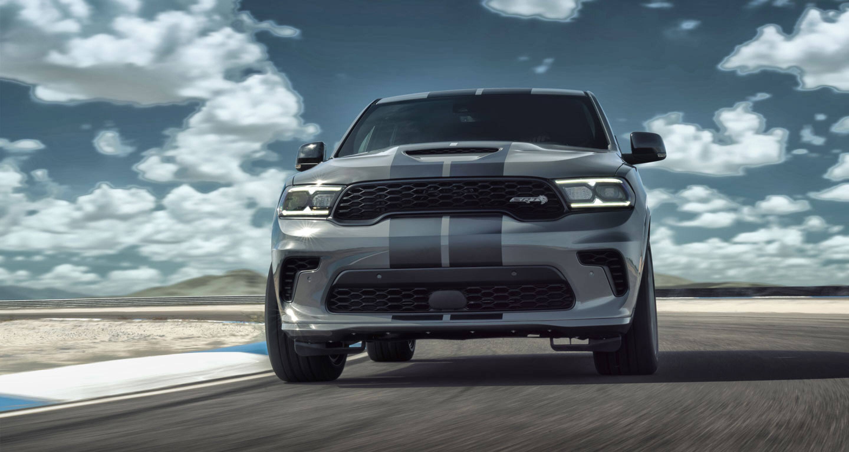 A gray 2021 Dodge Durango against a cloudy background.