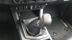 Driver's view of the stick shift in a 2021 Toyota Tacoma pickup truck.