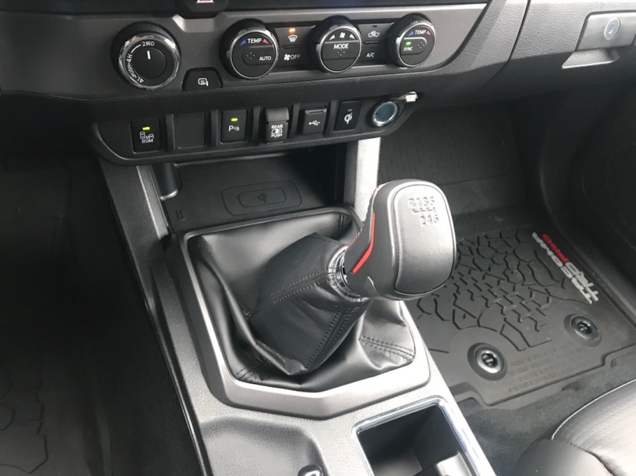Driver's view of the stick shift in a 2021 Toyota Tacoma pickup truck.