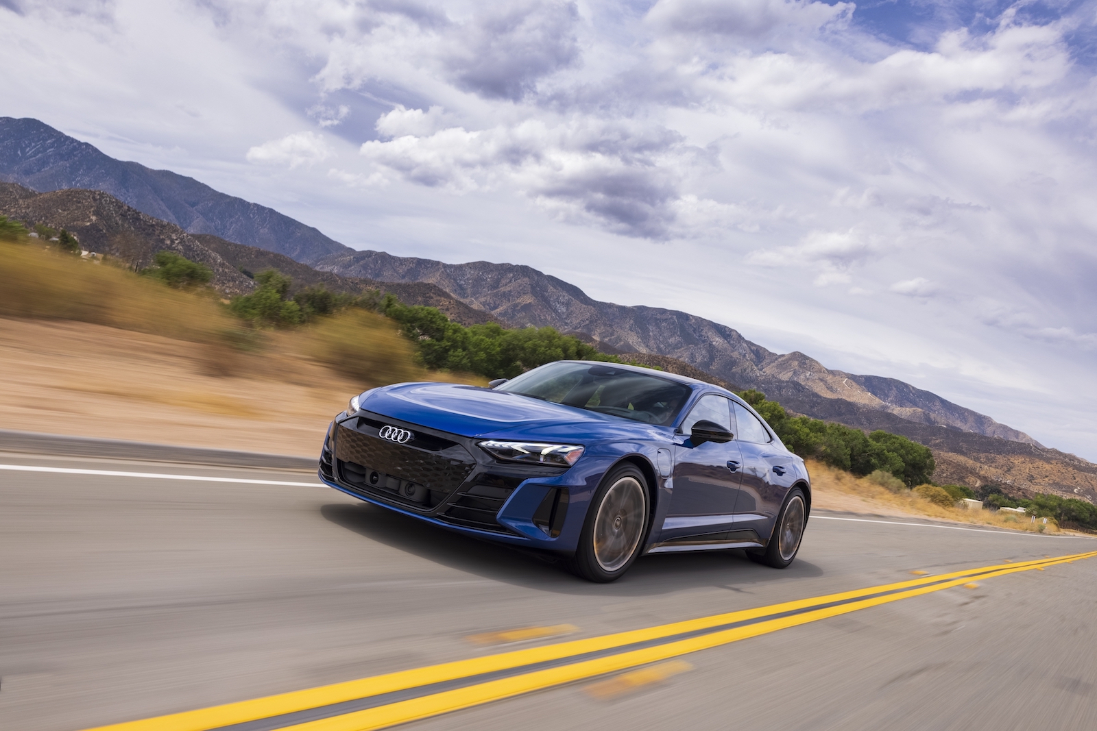 A blue 2022 Audi e-tron GT electric sports car driving