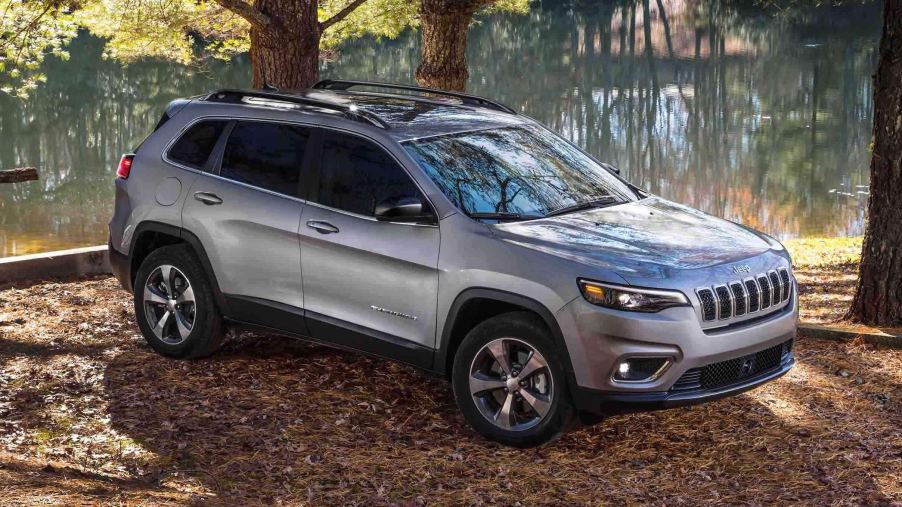 A silver 2022 Jeep Cherokee parked on the side of a trail.