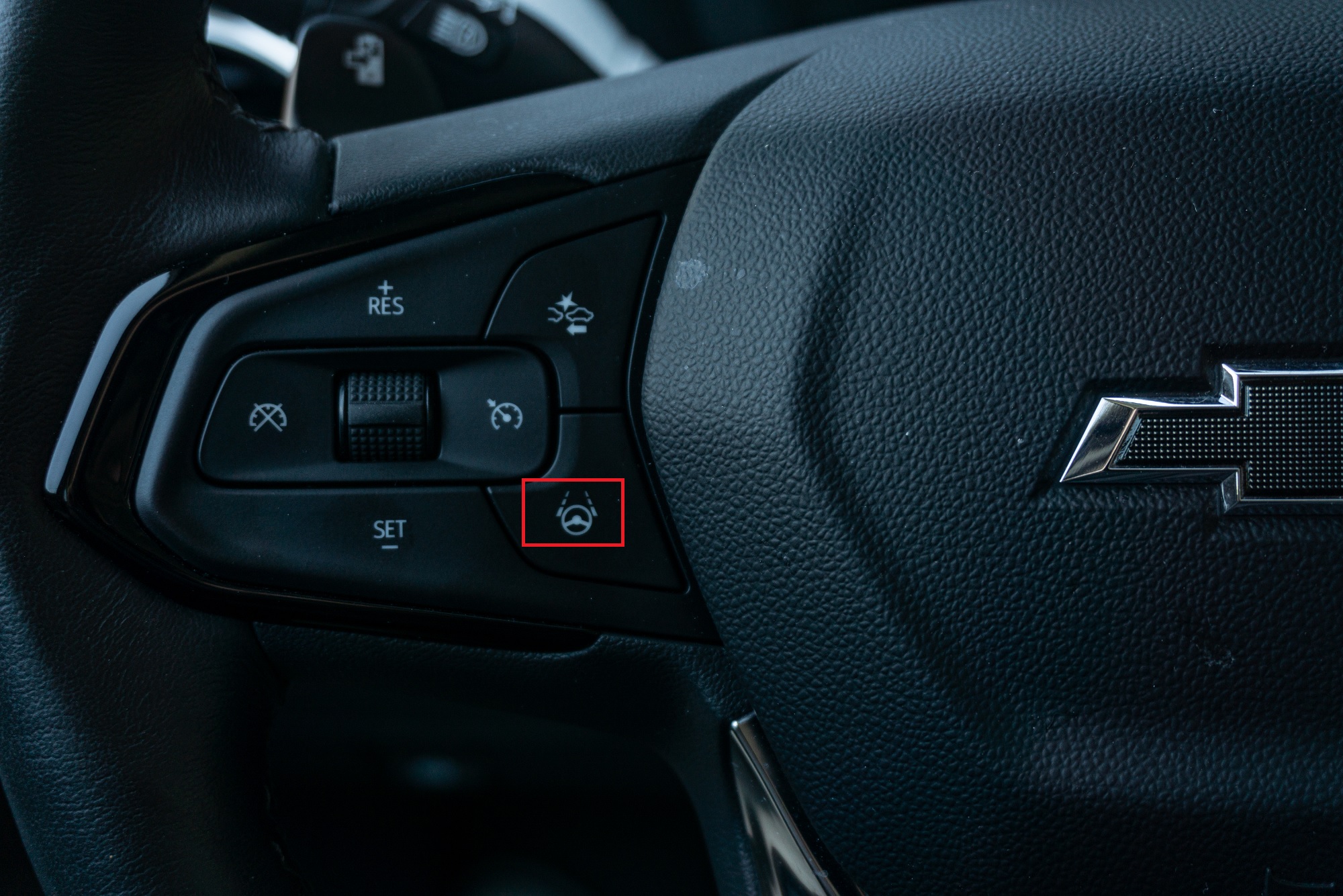 A 2022 Chevrolet Bolt EUV Premier's black-and-white adaptive cruise and Super Cruise controls with the latter highlighted in red