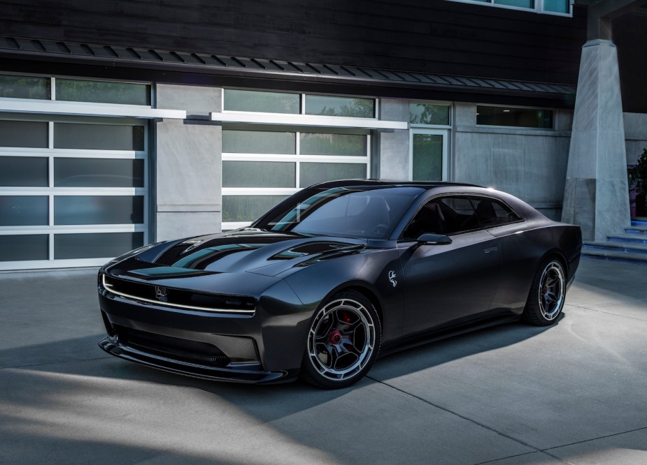 Promo photo of Dodge's Charger Daytona SRT concept electric vehicle, parked in front of a house.
