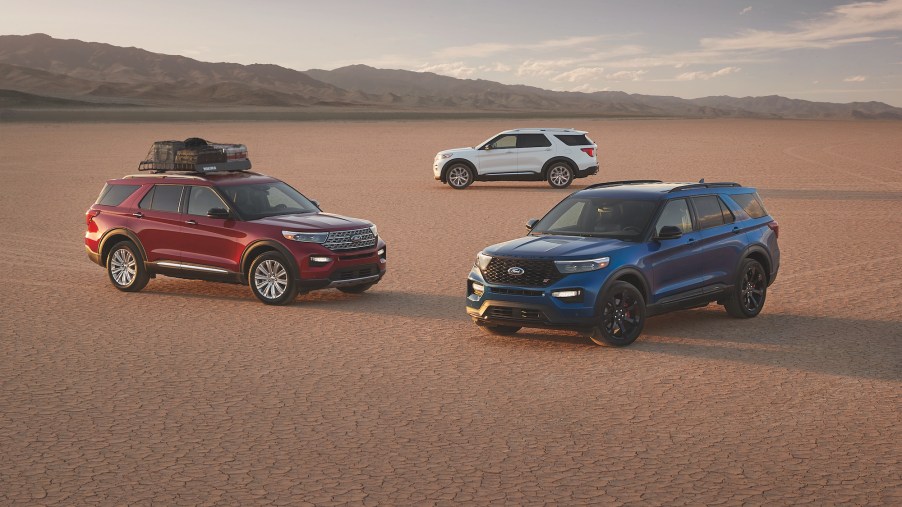 Three different 2022 Ford Explorers parked in a desert area.