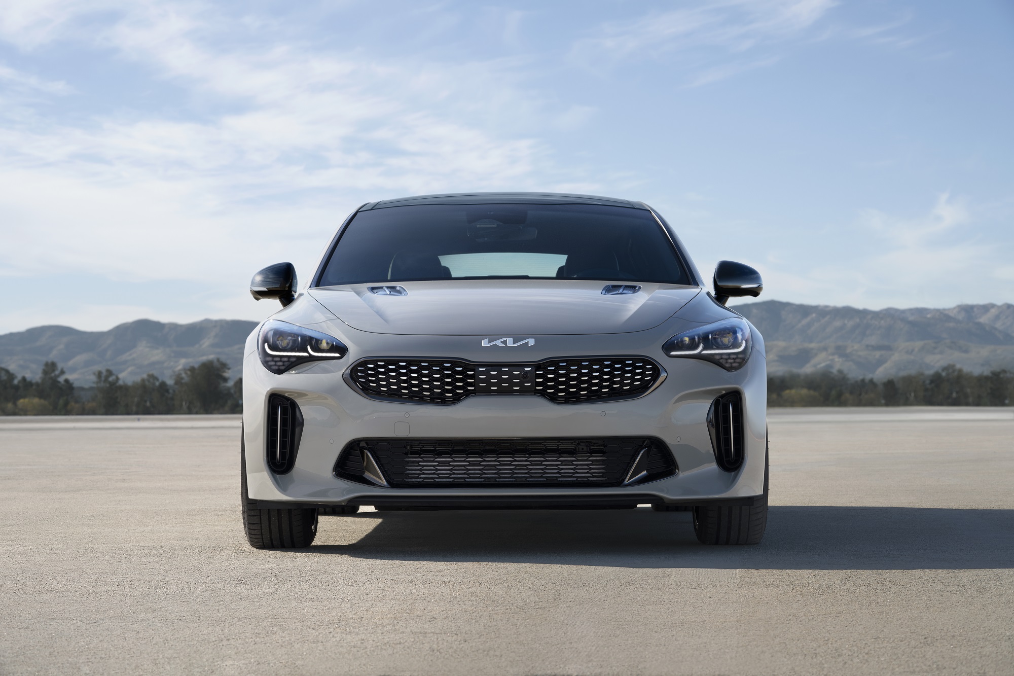 A gray Kia Stinger shows off its subtly styled front end.