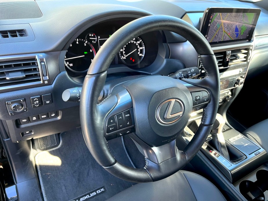 A view of the steering wheel and driver's seat of the 2022 Lexus GX 460