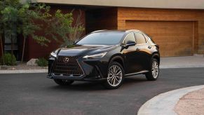 A 2022 Lexus NX luxury compact SUV model parked outside a luxury home with a wooden garage