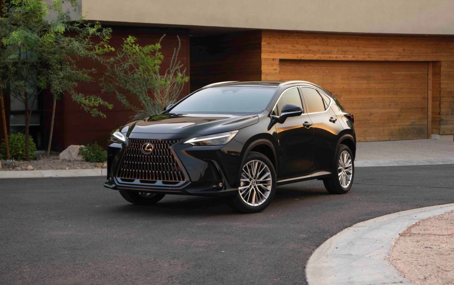 A 2022 Lexus NX luxury compact SUV model parked outside a luxury home with a wooden garage