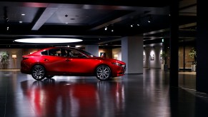 A red 2022 Mazda 3 parked indoors.
