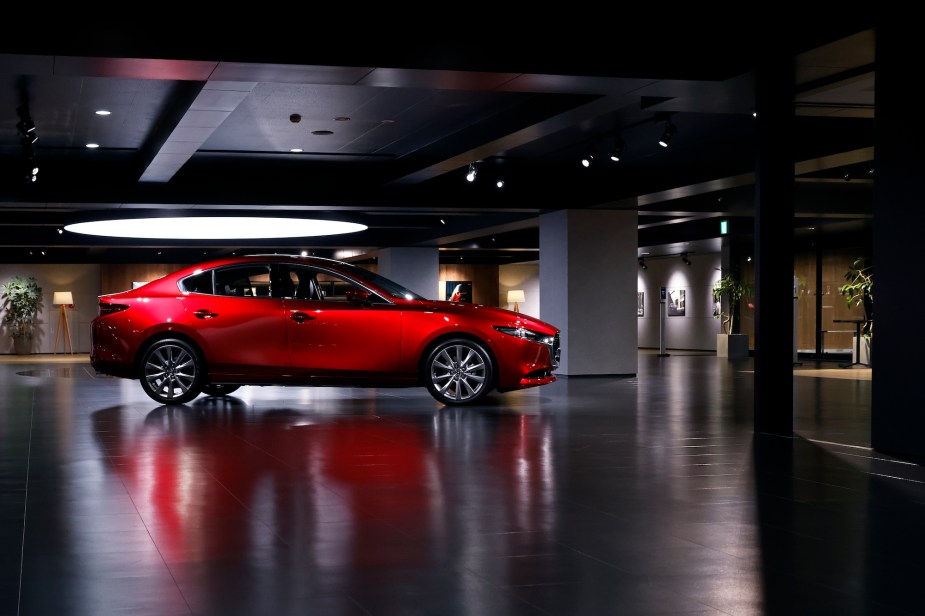 A red 2022 Mazda 3 parked indoors. 