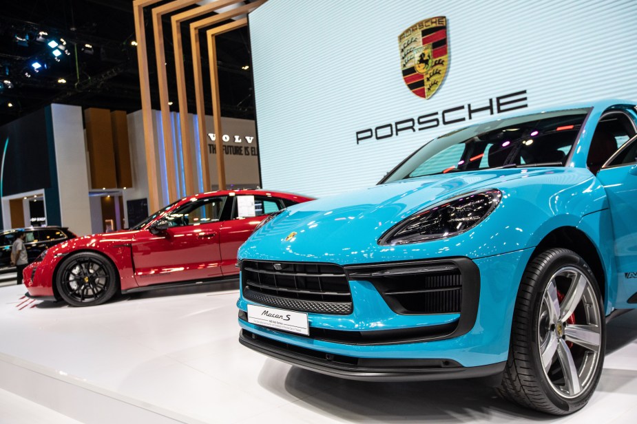A light blue and a red 2022 Porsche Macan.