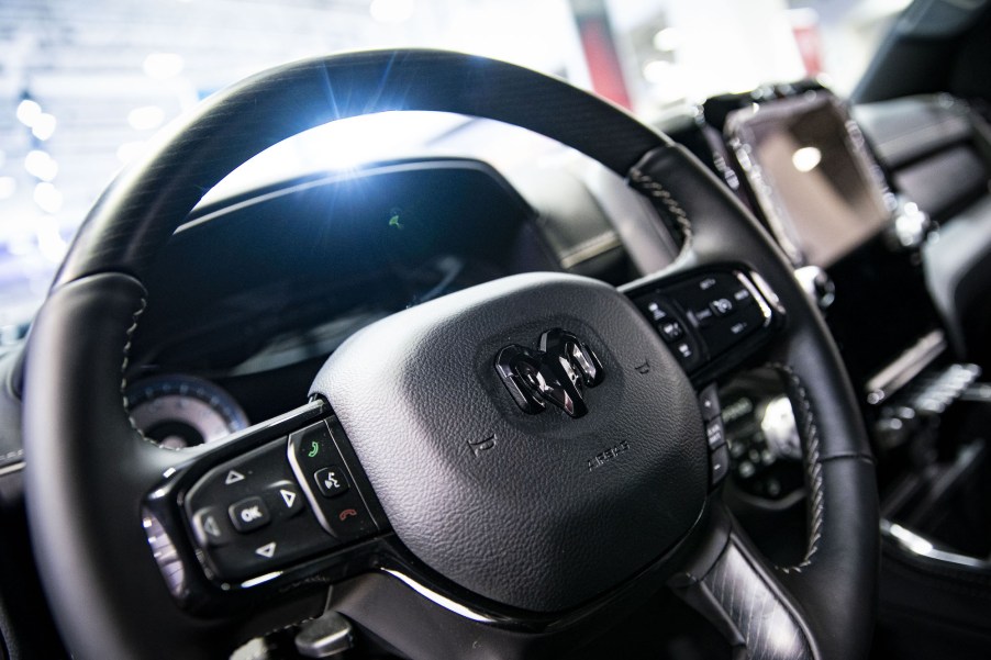 The steering wheel and infotainment screen of a Ram pick up truck.