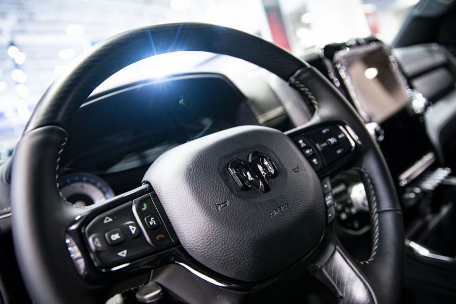 The steering wheel and infotainment screen of a Ram pick up truck. 