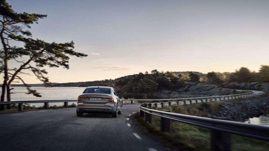 2022 Volvo S60 driving down a road.