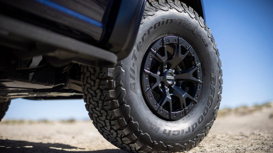 Closeup of a Ford F-150 tire parked in the desert.