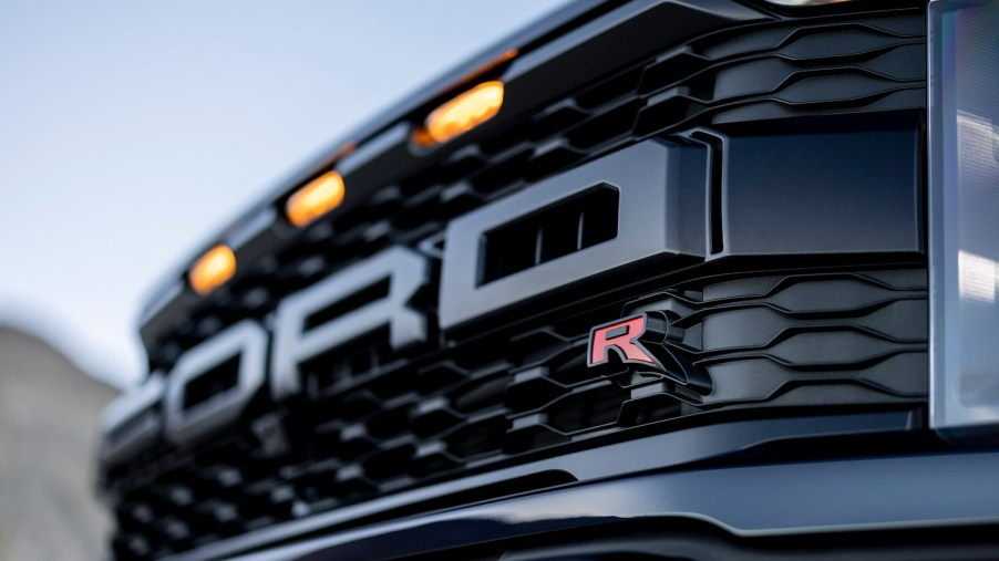 The grille of a Ford Raptor R pickup truck with amber marker lights for clearance reasons.