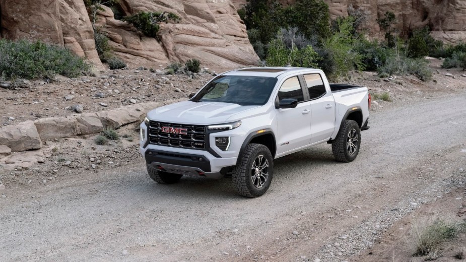 White 2023 GMC Canyon AT4 on a dirt road