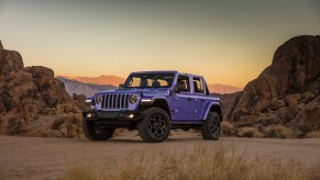 A purple 2023 Jeep Wrangler Unlimited 4xe parked in the desert.