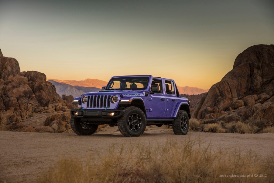 A purple 2023 Jeep Wrangler Unlimited 4xe parked in the desert.