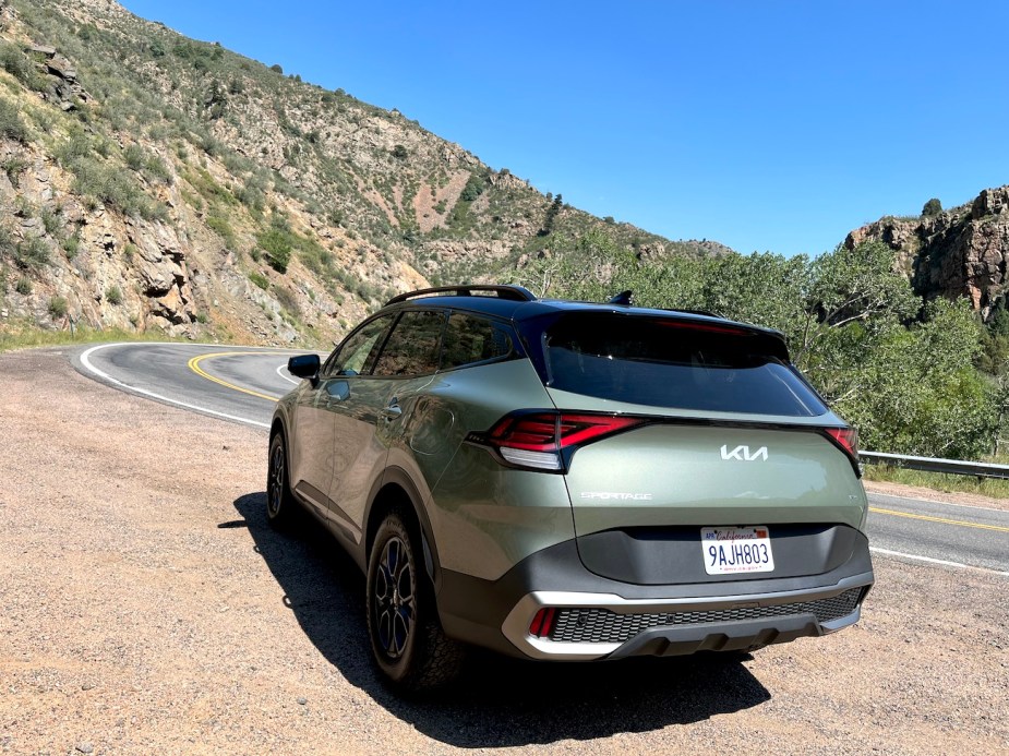 The 2023 Kia Sportage sits on the side of a canyon road.