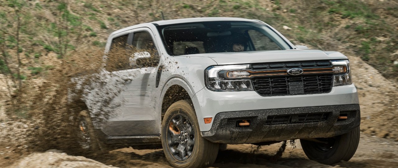 A grey 2023 Maverick Tremor climbing a hill