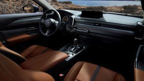 A view of the 2023 Mazda CX-50 cabin interior front seating and dashboard