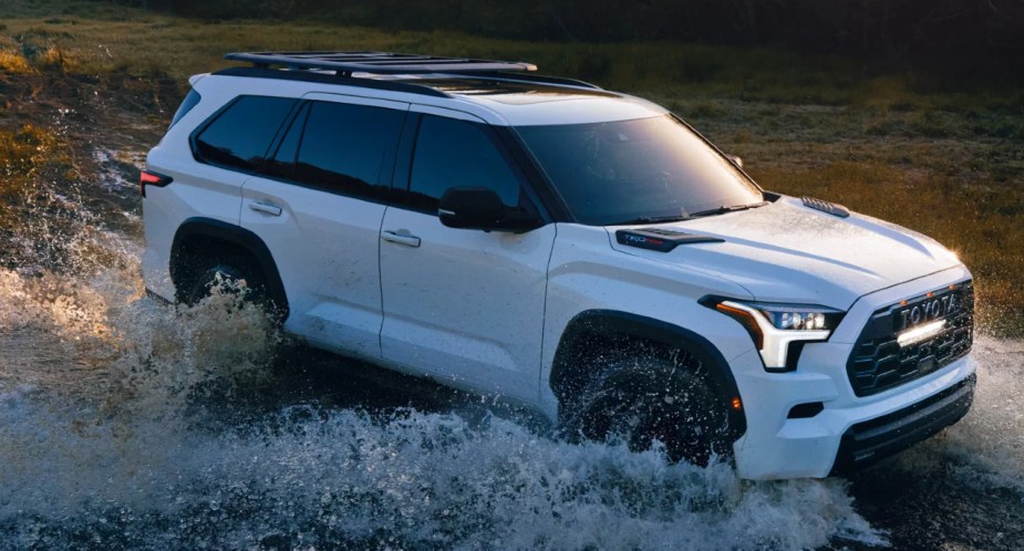 White 2023 Toyota Sequoia SUV splashing through some water
