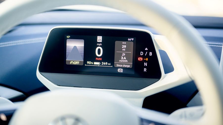 The driver's display behind a steering wheel of a 2023 Volkswagen ID. 4 all-electric SUV (EV) model