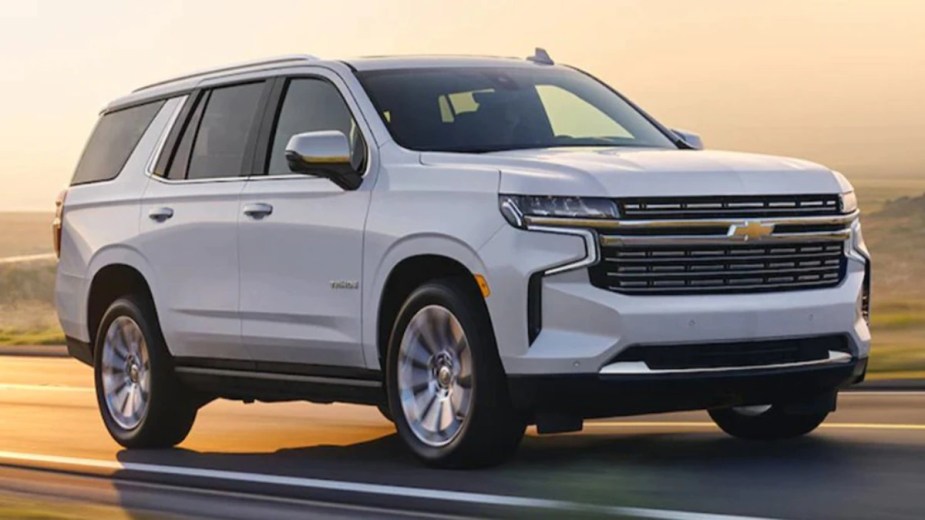A 2023 Chevrolet Tahoe in white on a road. 