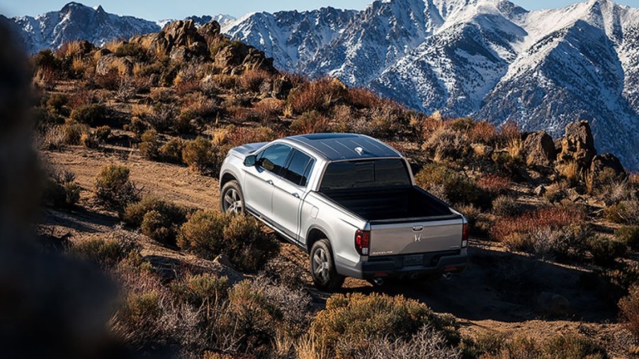 A 2023 Honda Ridgeline climbs up a steep hill as a mid-size truck.