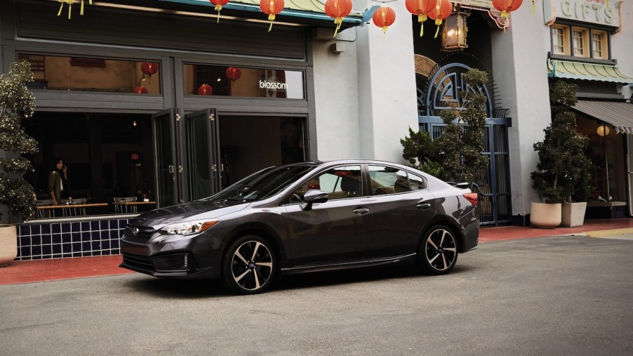 A side view of the 2022 Subaru Impreza on a private street.