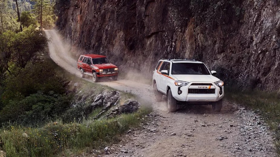 A white Toyota 4Runner from 2023 followed by a 4Runner from 1983.