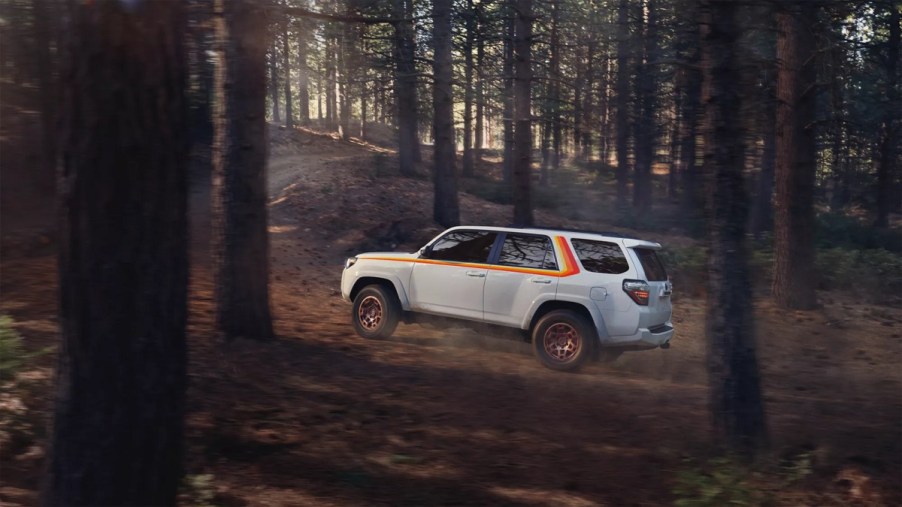A white 2023 Toyota 4Runner Anniversary Edition driving up a hill.