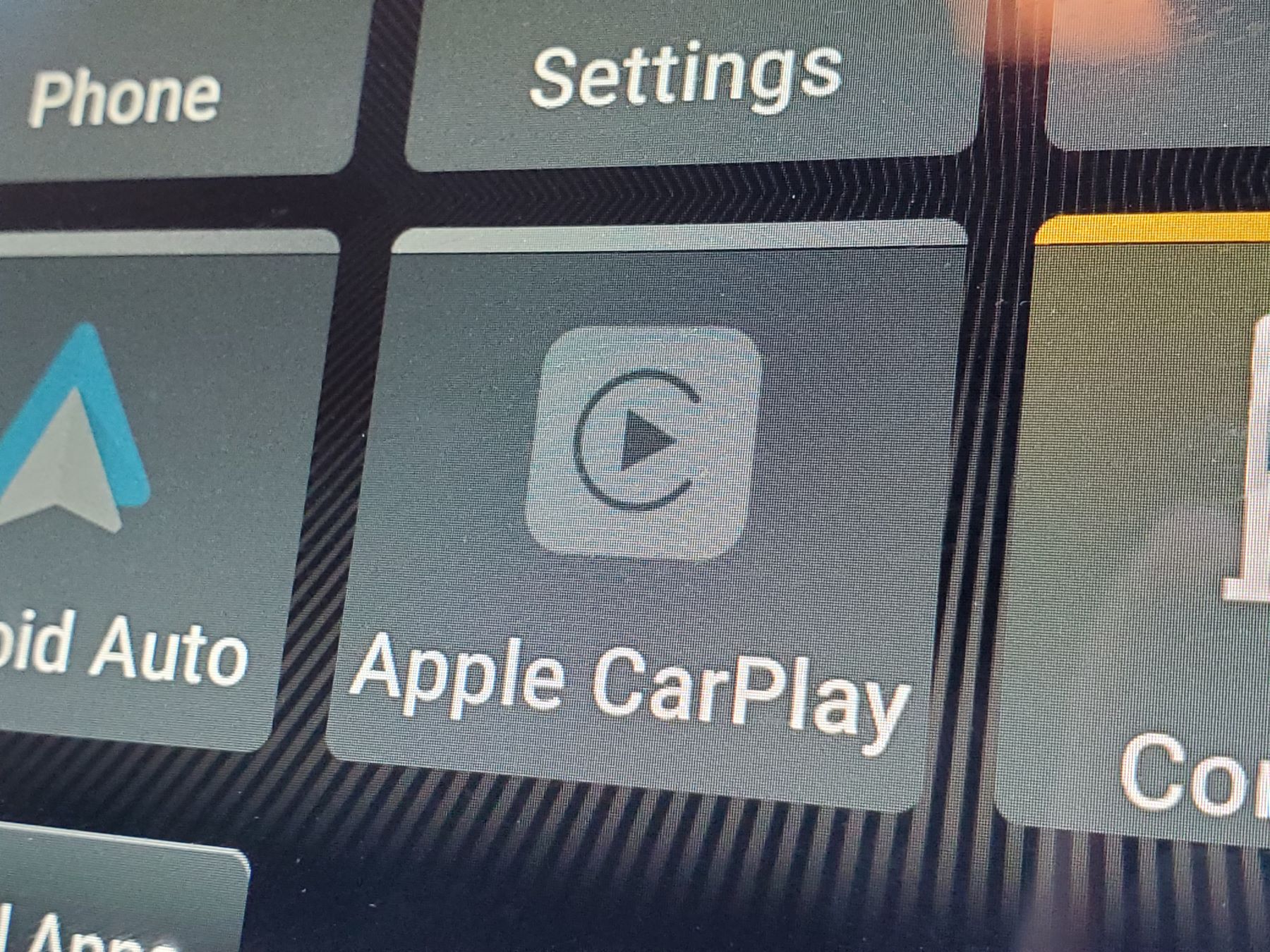The Apple CarPlay icon on a vehicle dashboard display